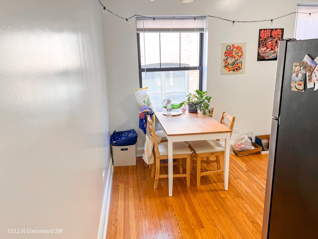 a dining room with a table and chairs and a window