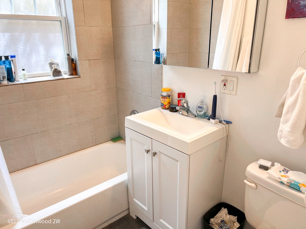 a small bathroom with a sink and a bath tub