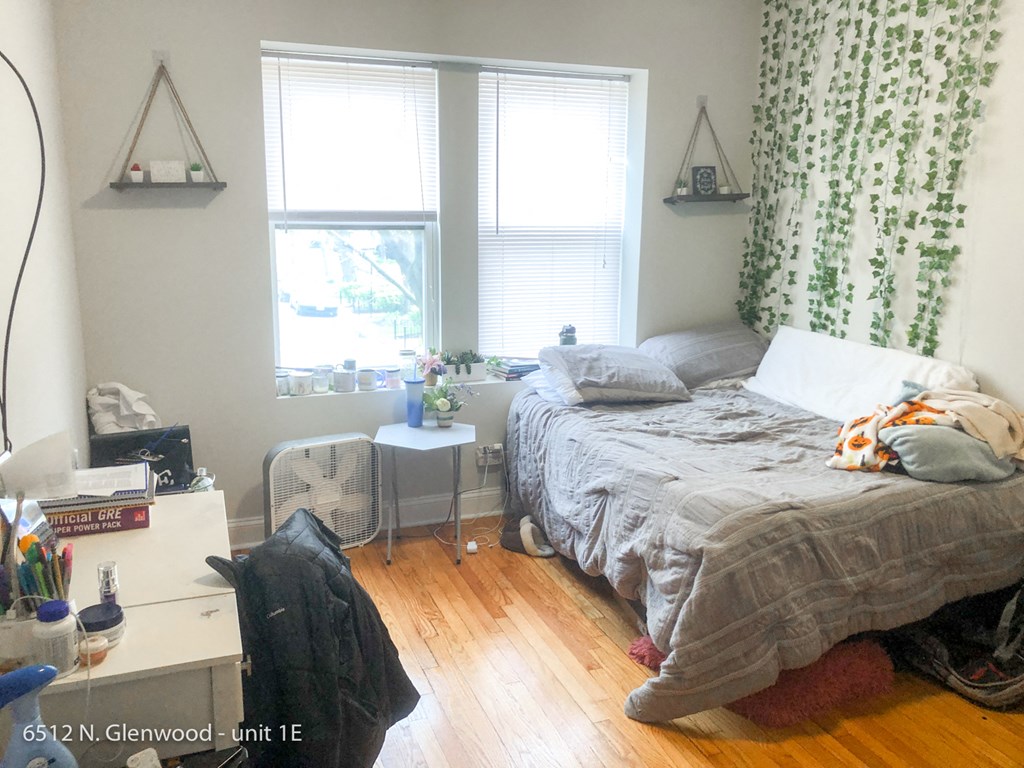 a bedroom with a bed and two windows