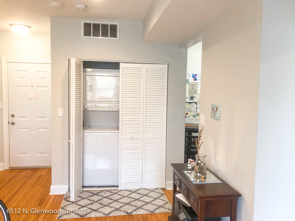 a small living room with a closet and a wood floor