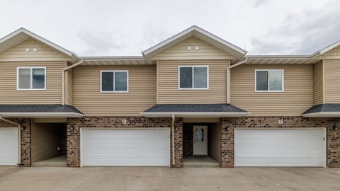 A row of houses with garages in front.