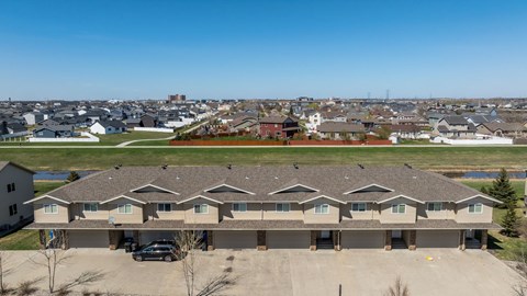 A large building with a parking lot in front of it.