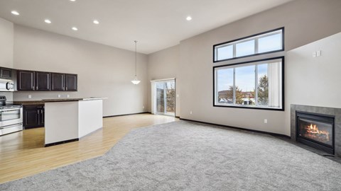 A modern kitchen with a fireplace and a view of the outdoors.