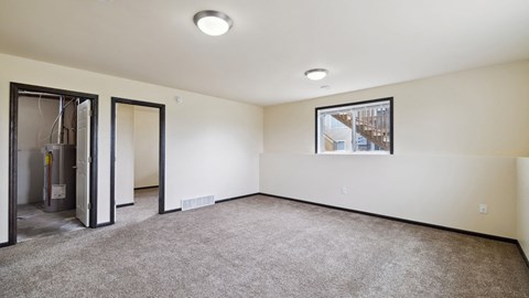A room with a carpeted floor and a picture on the wall.