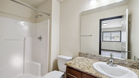 A bathroom with a sink, toilet, and shower.