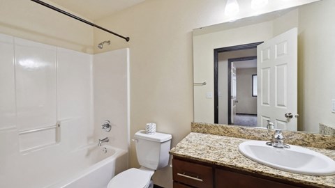 A white toilet sits next to a sink in a bathroom.