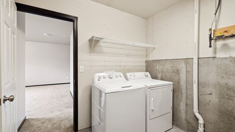 A white washer and dryer in a small laundry room.