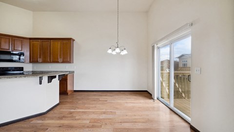 A kitchen with wooden floors and white walls.