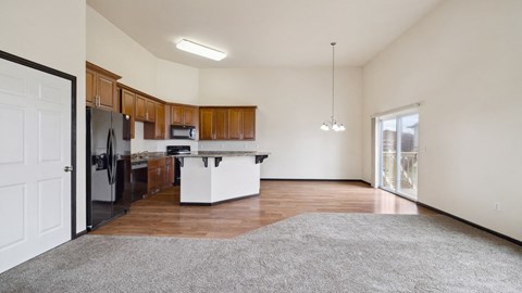 A kitchen with wooden cabinets and a white island.