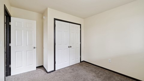 A room with two doors, one of which is open.