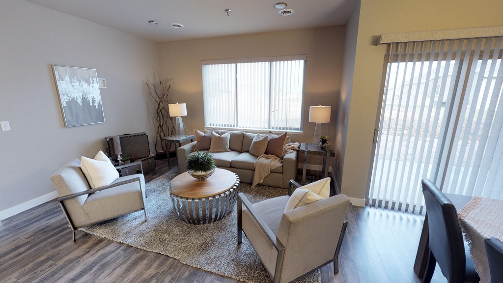 a living room with couches and chairs and a table