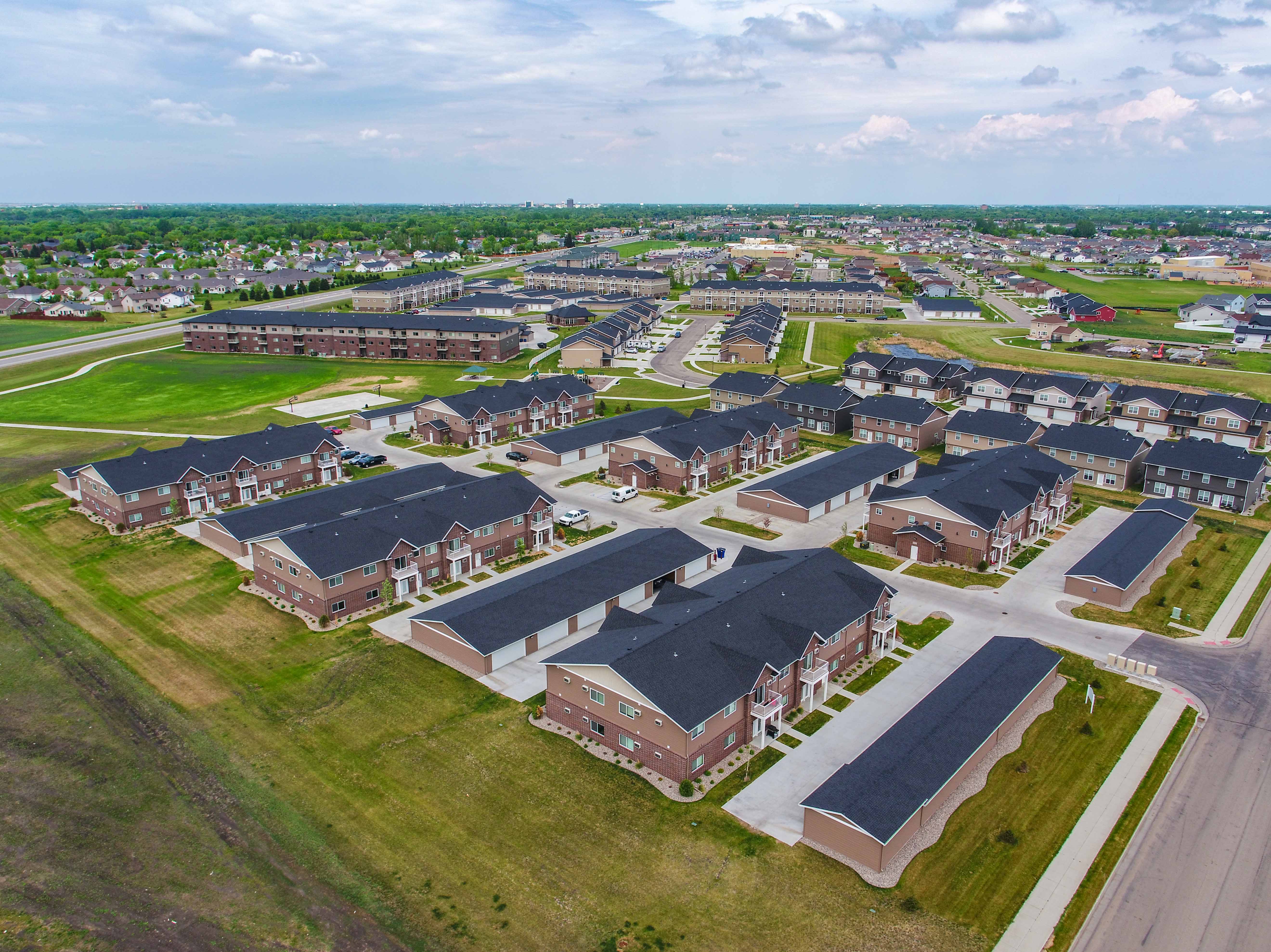 an aerial view of a suburb of a city with rows of houses