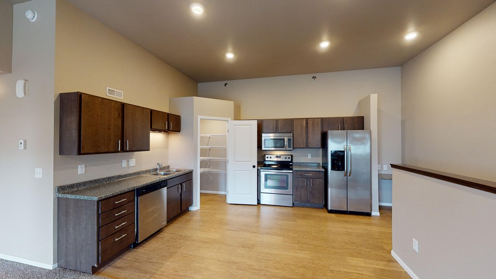 a kitchen with stainless steel appliances and wooden cabinets
