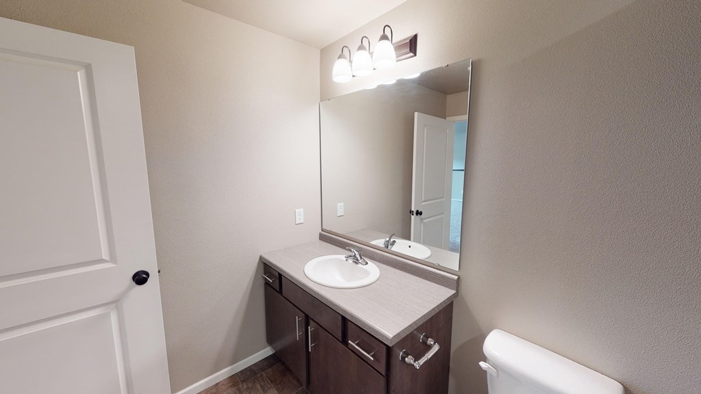an empty bathroom with a sink and a mirror
