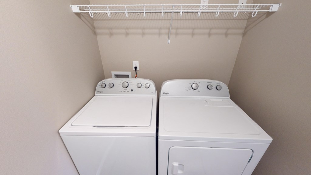 two washers and dryers in the laundry room of a home