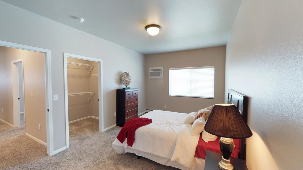 bedroom with dresser and bed, moorhead apartment