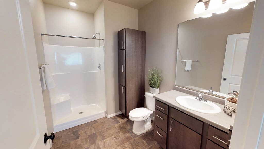 bathroom, shower, sink, mirror, toilet, linen closet, moorhead apartment