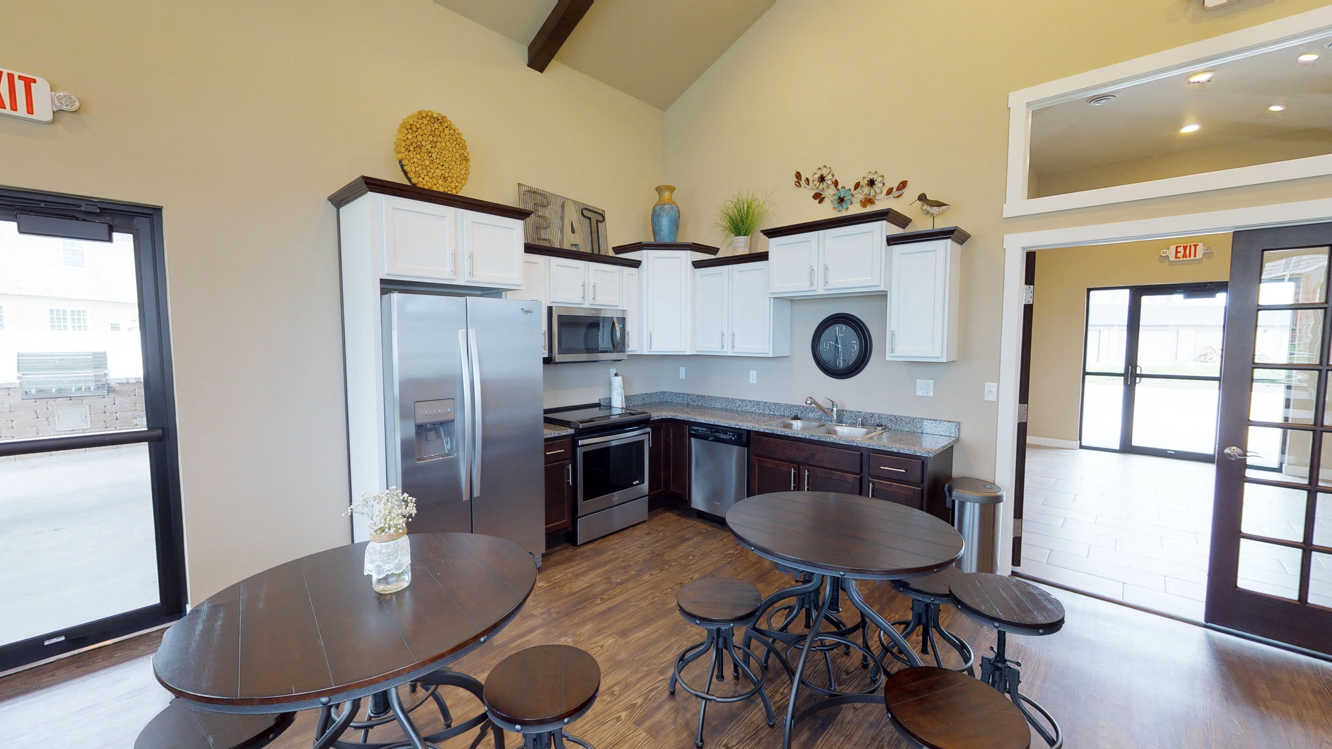 a kitchen with stainless steel appliances and a table and chairs