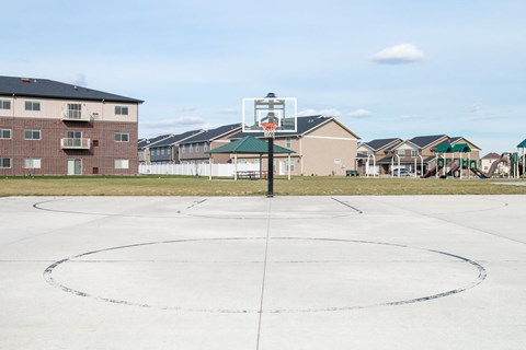 a basketball hoop in the middle of an empty parking lot