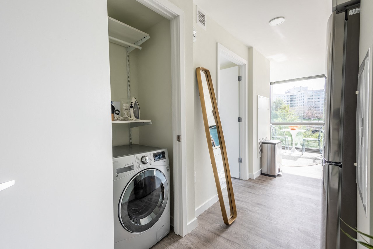 a washer and dryer in a room with a door to a laundry room