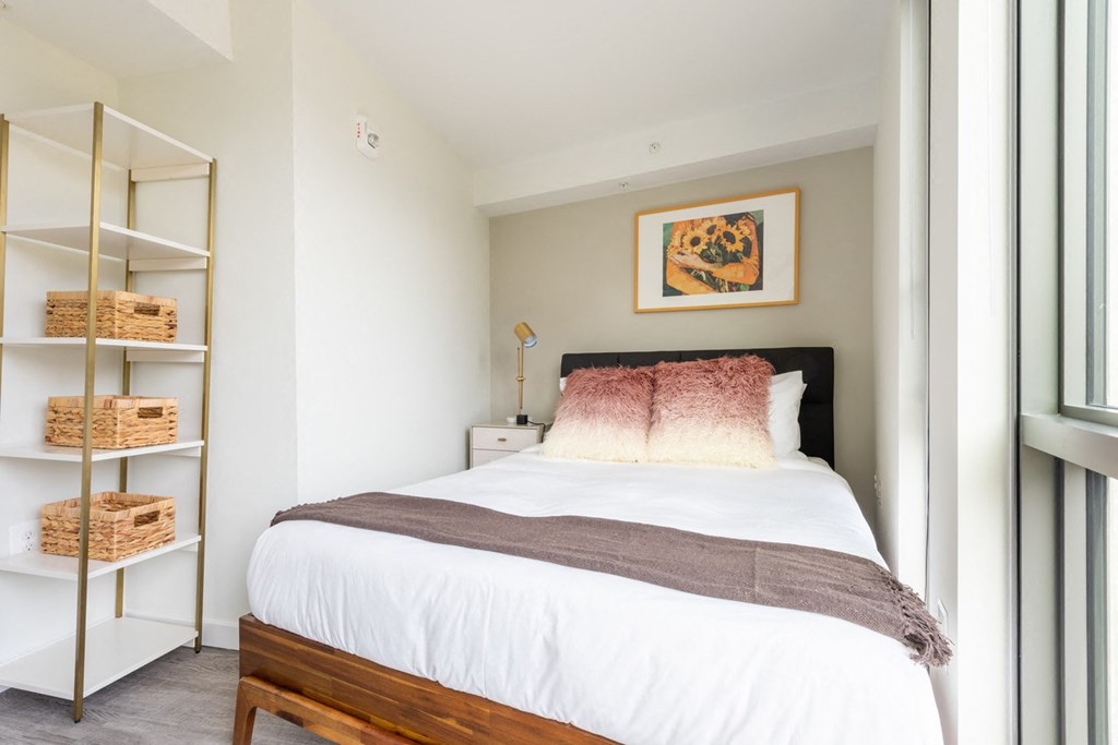 a bedroom with a white bed and a white closet