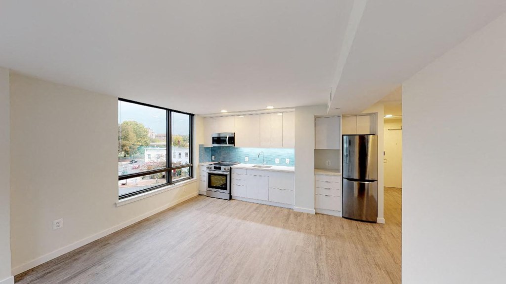 a kitchen with a stainless steel refrigerator and a sink