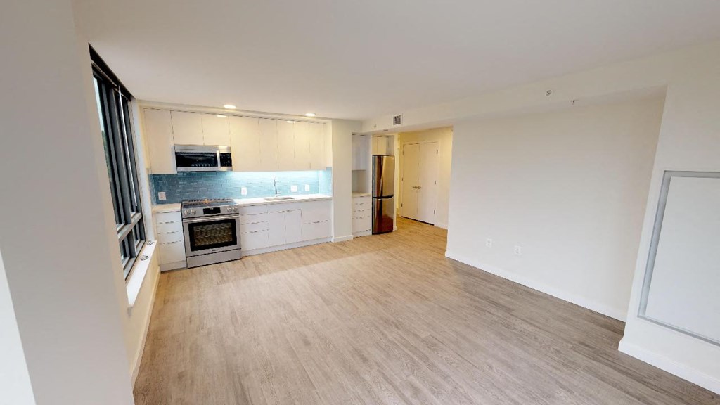 a kitchen and living room with a wood floor