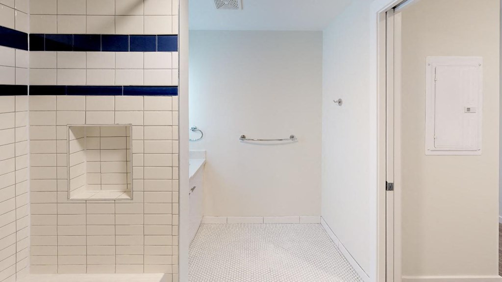 a white bathroom with a shower and a sink