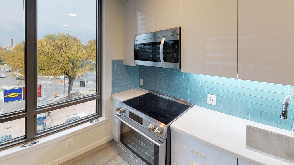 a kitchen with a stove and a window