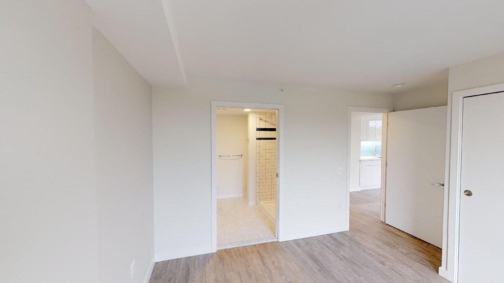 a bedroom with a closet and a mirror in a house