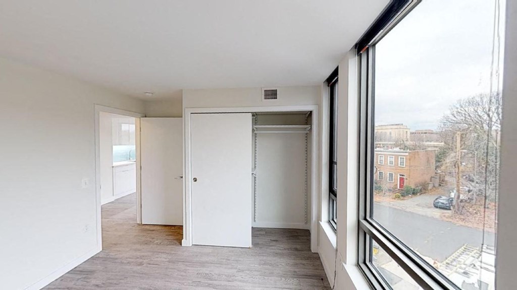 a living room with a large window and a door to a closet