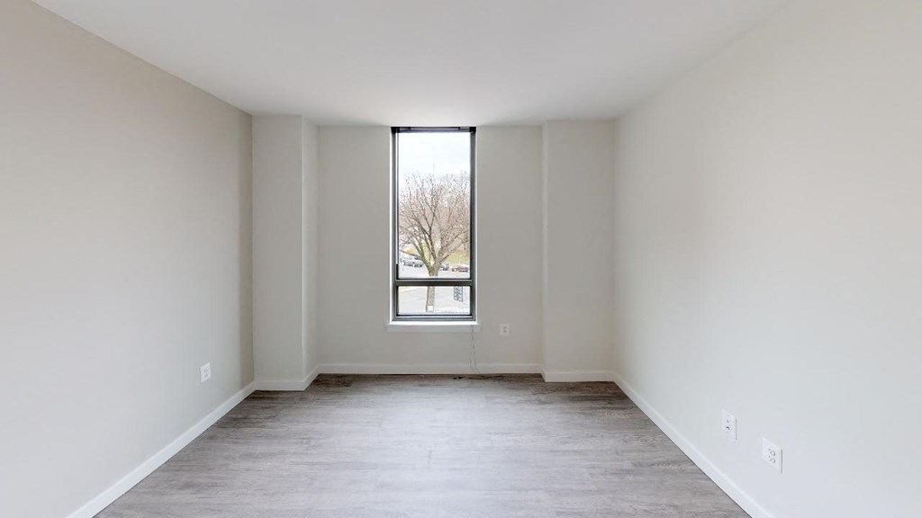 an empty living room with a large window