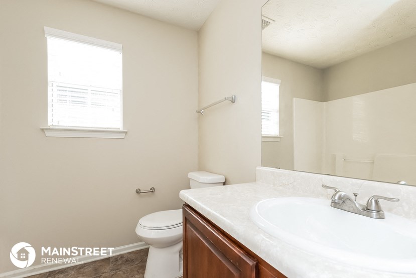 a bathroom with a sink and a toilet and a mirror