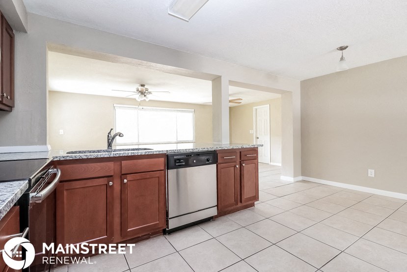 a kitchen with wooden cabinets and stainless steel appliances