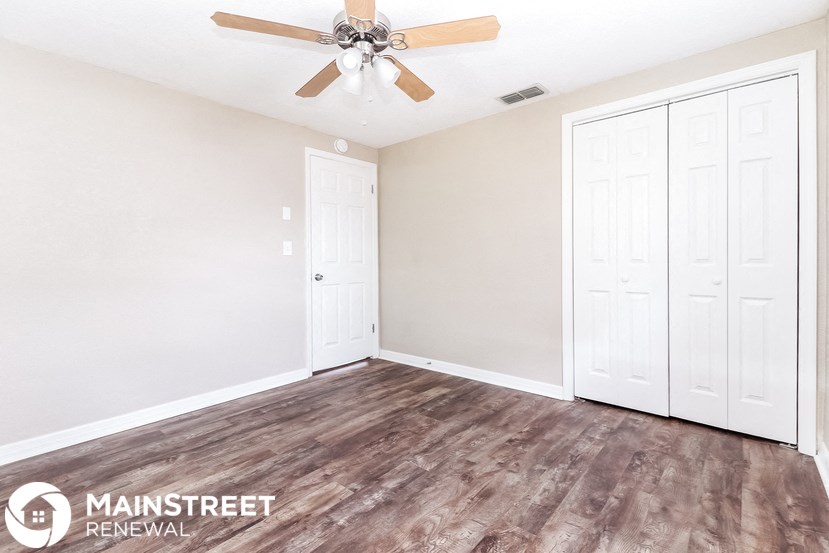 the master bedroom has a ceiling fan and two closets