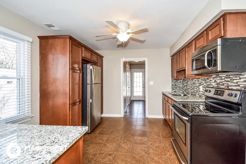 a kitchen with stainless steel appliances and wooden cabinets