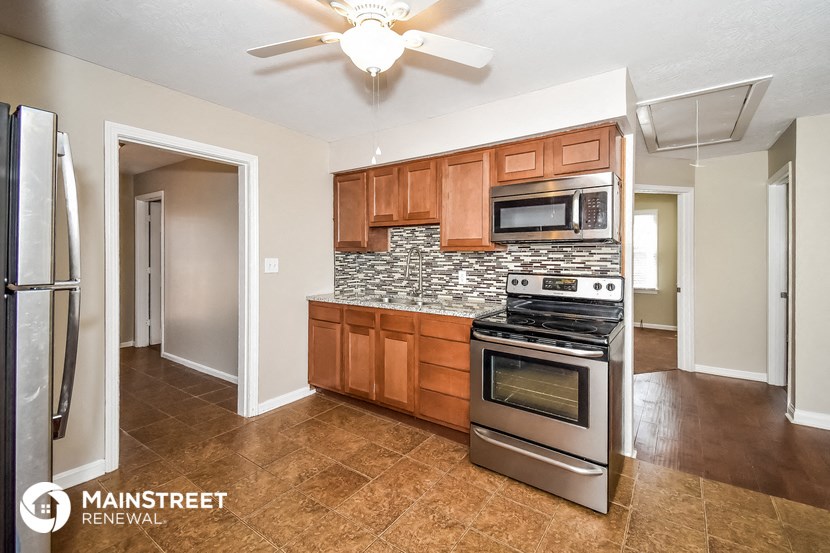 a kitchen with stainless steel appliances and wooden cabinets
