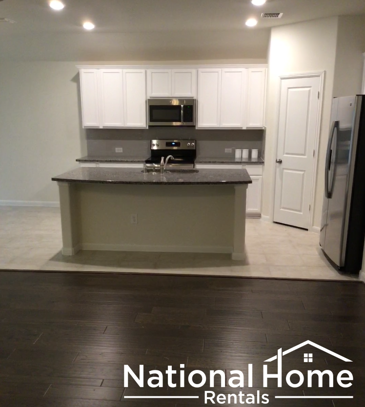 A kitchen with National Home Rentals logo.