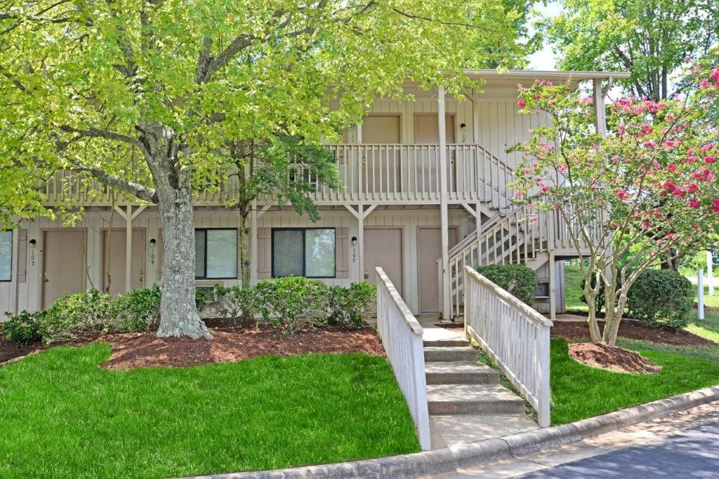 a building with stairs and trees in front of it