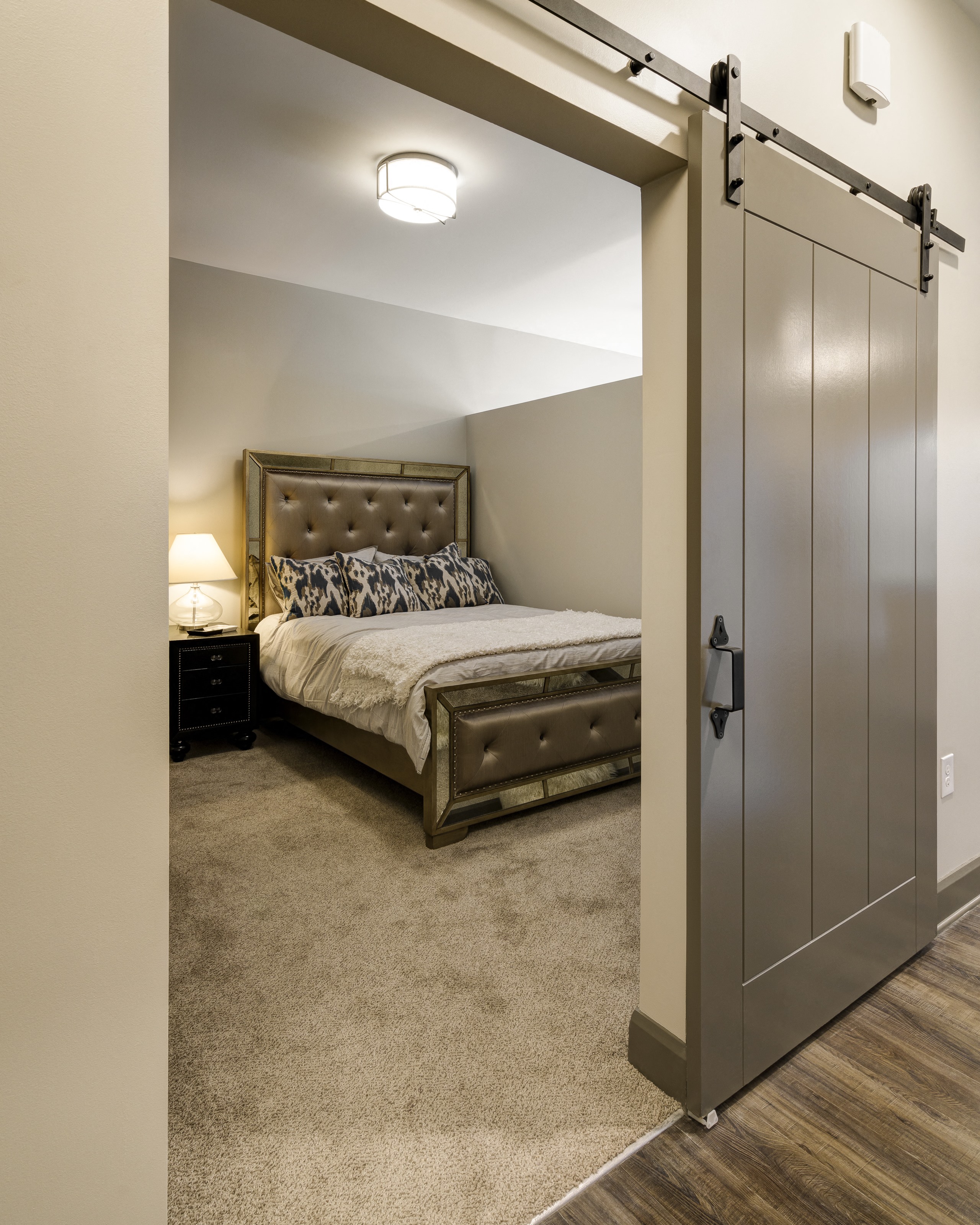 a bedroom with a bed and a sliding barn door