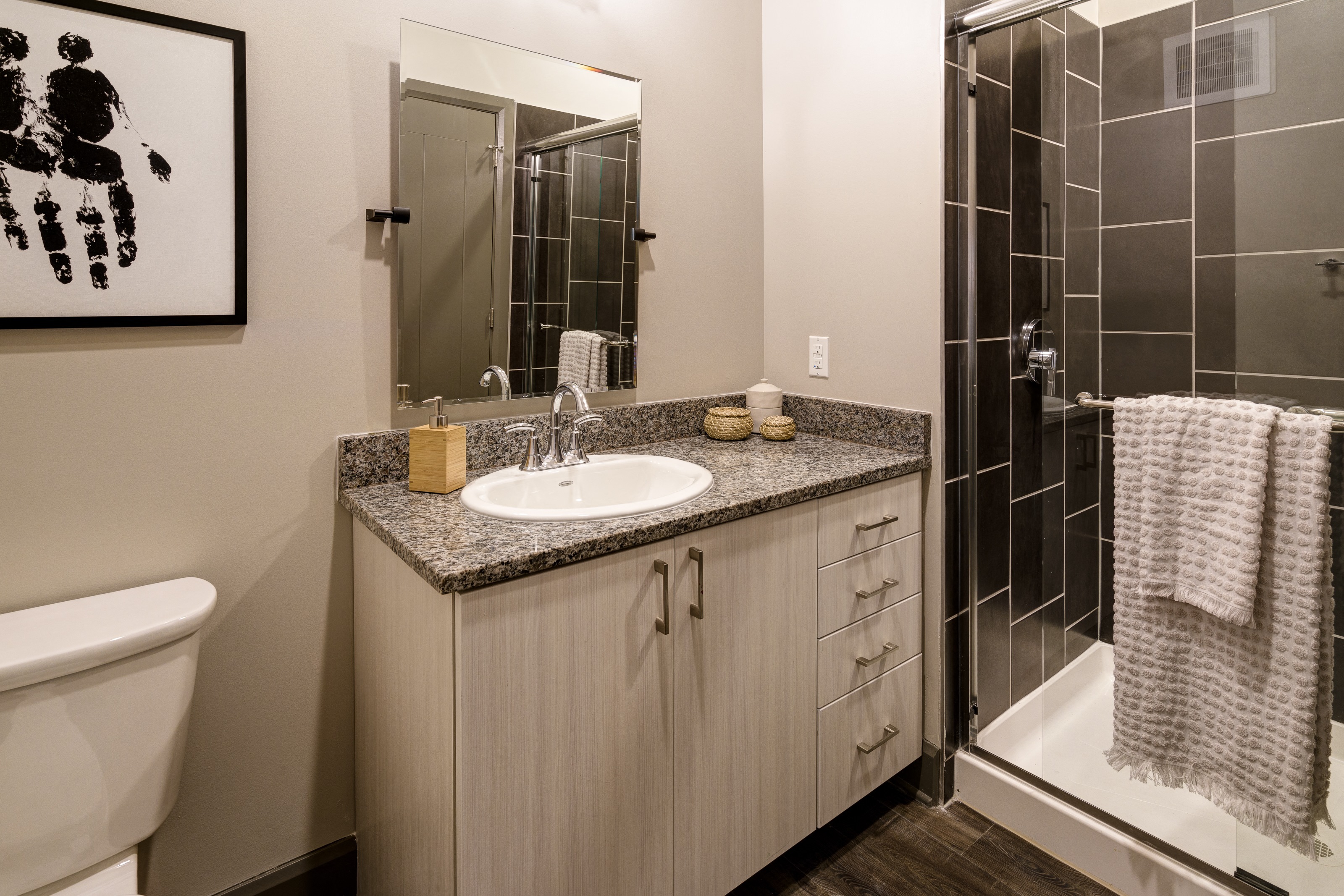 a bathroom with a sink and a shower and a toilet