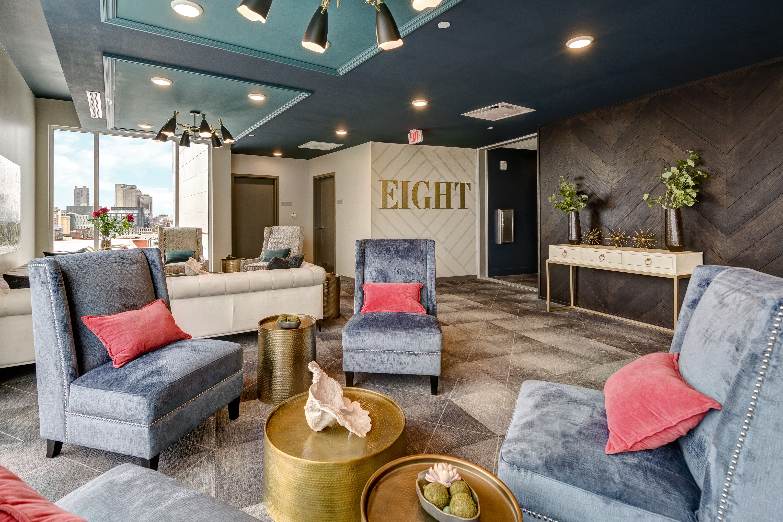 a lobby with couches and chairs and a reception desk