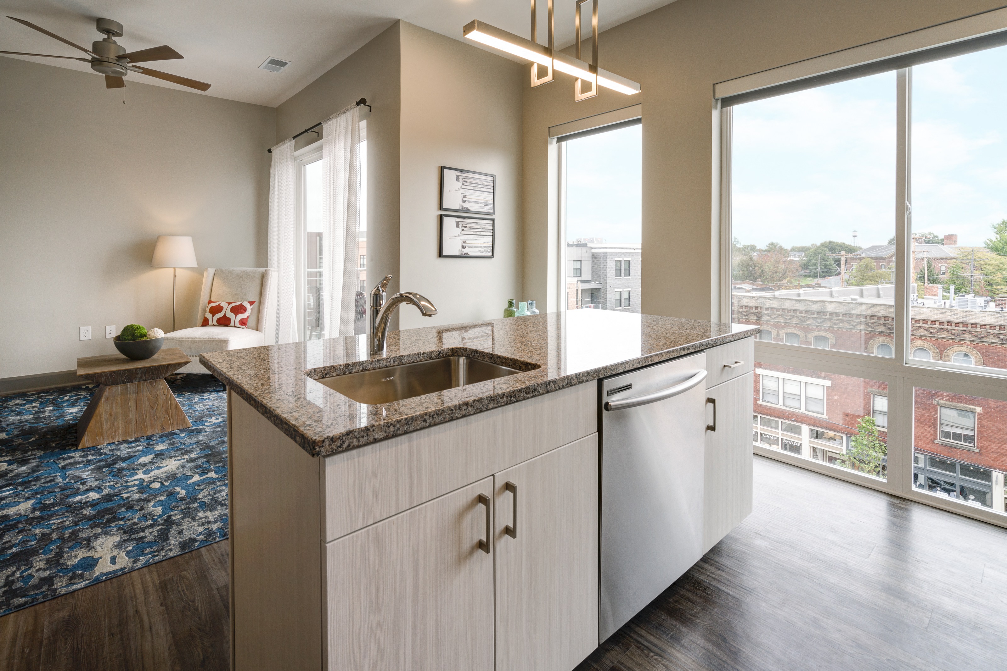 a kitchen with a sink and a view of a living room