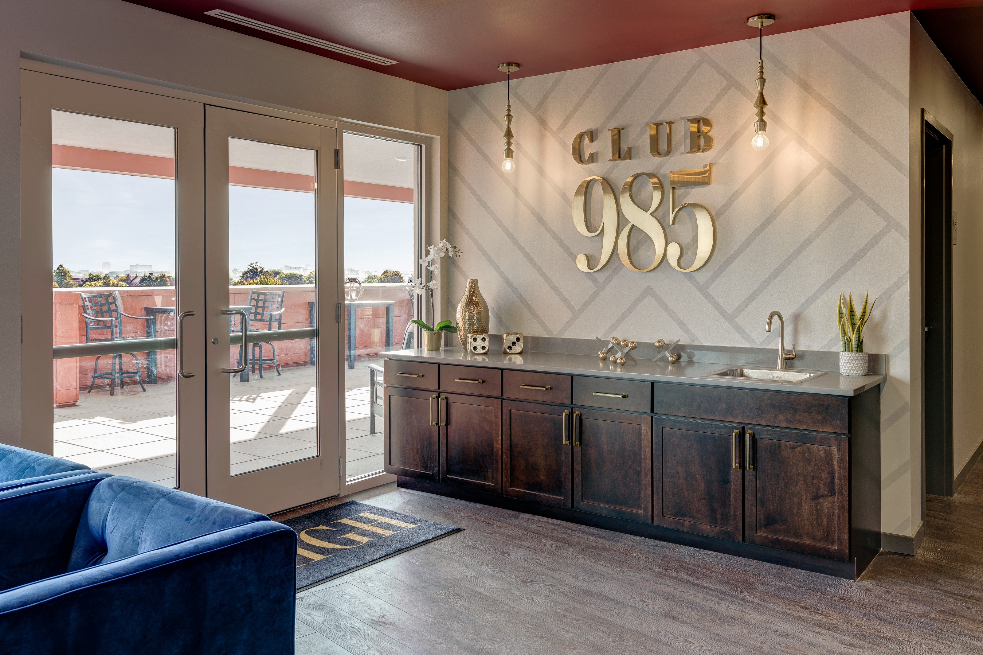 a clubhouse with a bar and sliding glass doors to a patio