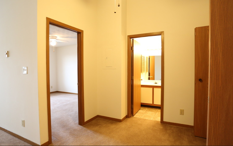 Image of a carpeted master bedroom and bathroom