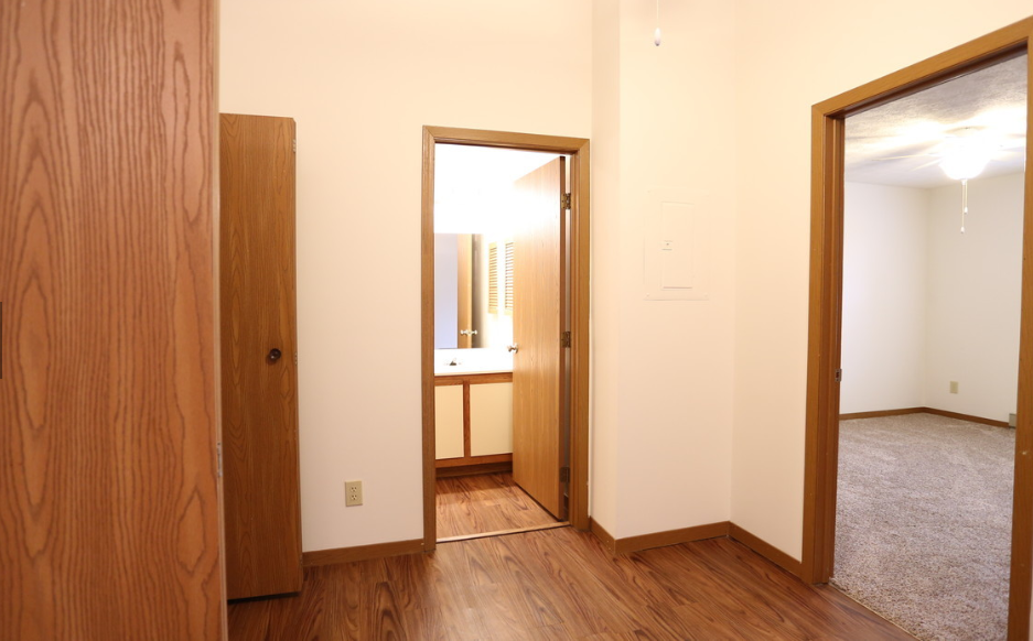 Image of master bedroom with vinyl plank flooring and bathroom