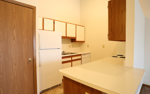 a kitchen with a refrigerator and a sink
