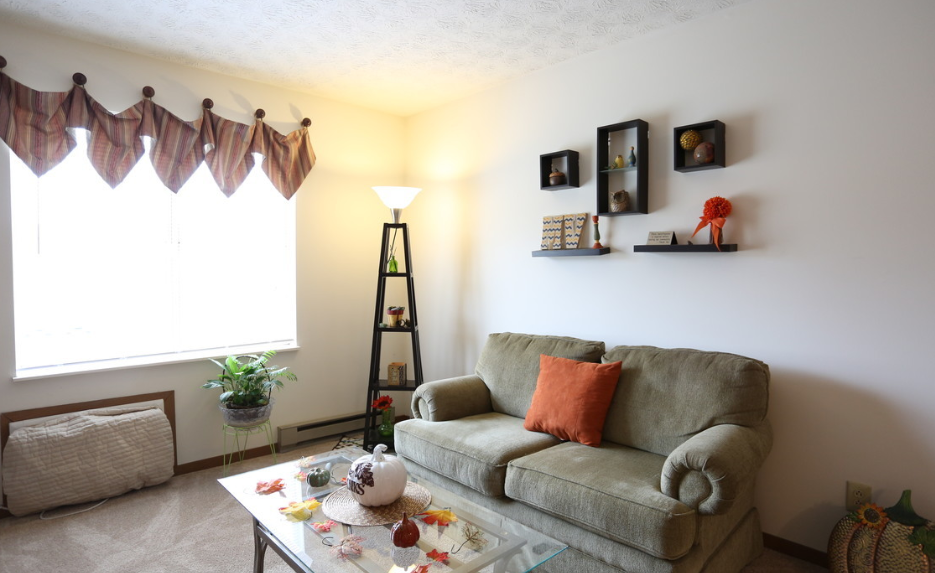 Image of a living room with couch, coffee table, and lamp
