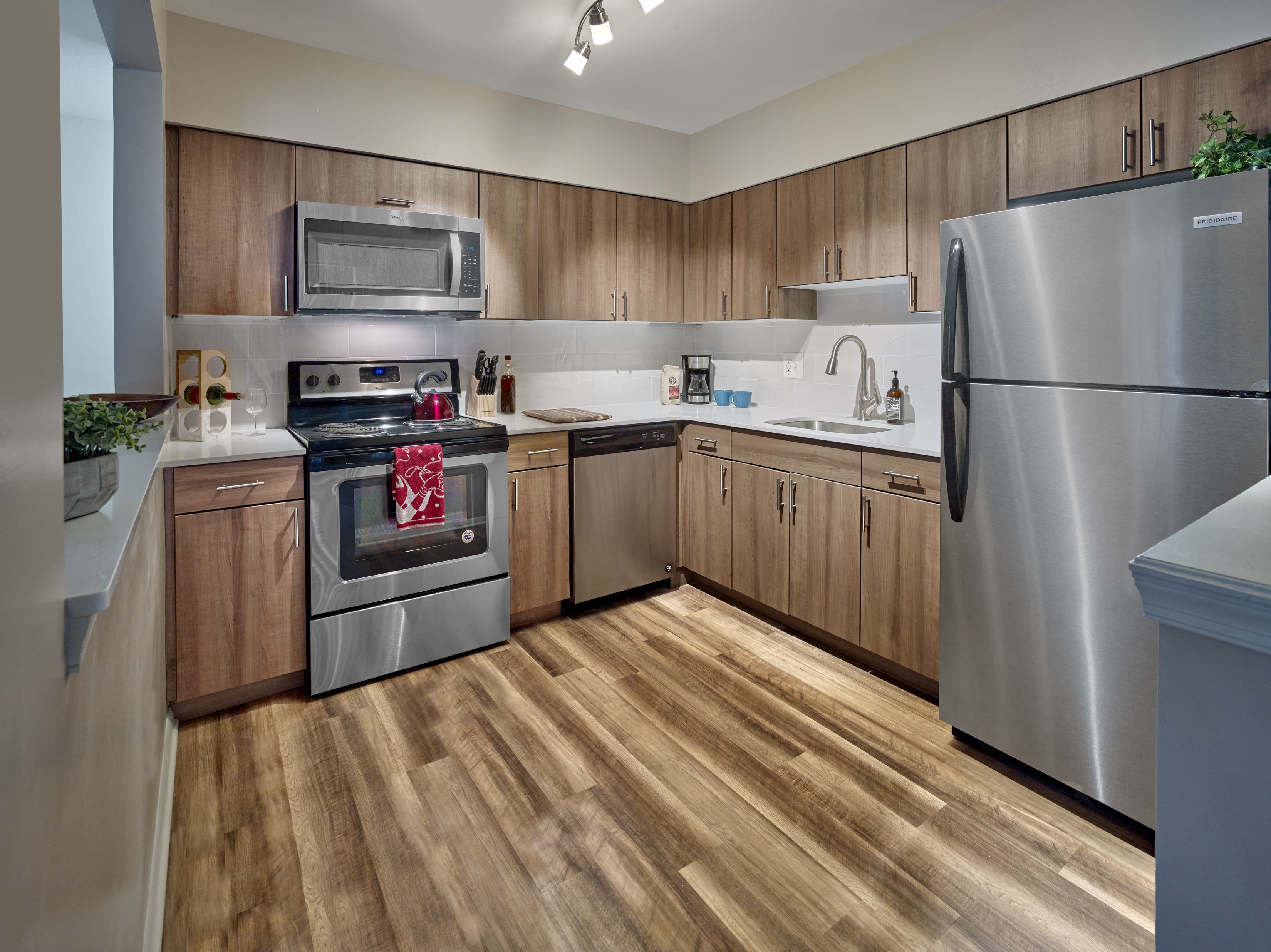 a kitchen with stainless steel appliances and wooden cabinets