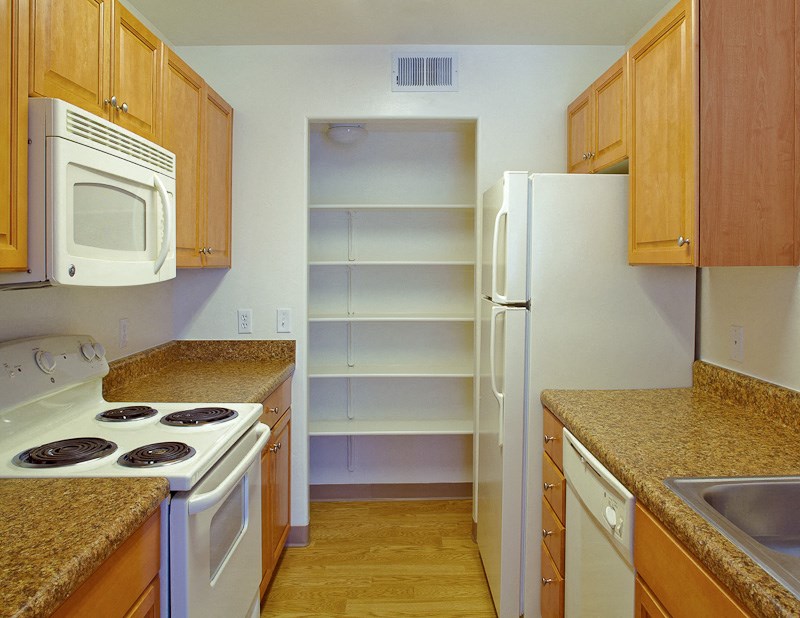 a kitchen with white appliances and granite counter tops